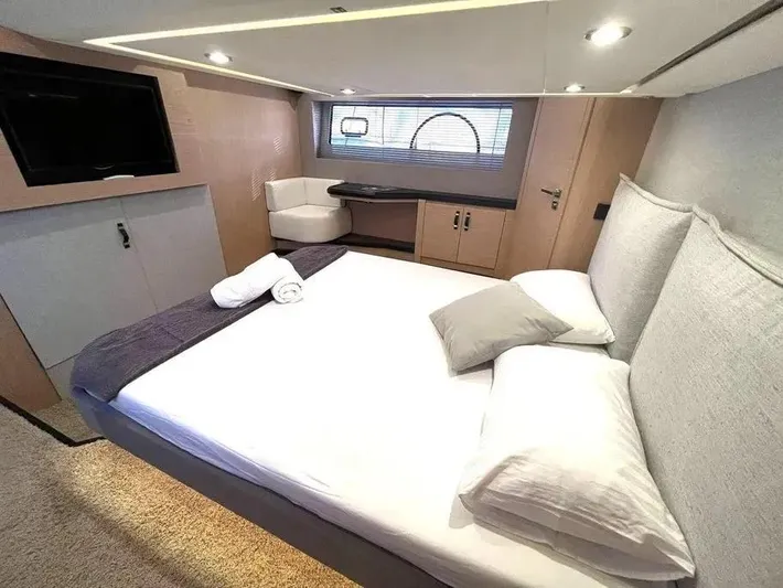 Rialtin Yacht Photos Pics Luxurious bedroom interior of 2022 Beneteau Monte Carlo 52 yacht, featuring modern design and cozy bedding.
