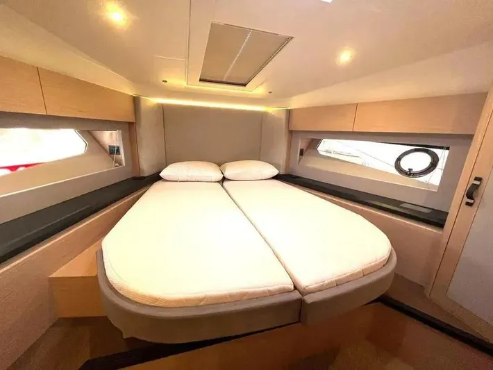 Rialtin Yacht Photos Pics Luxurious cabin interior of 2022 Beneteau Monte Carlo 52 yacht, featuring a cozy double bed.