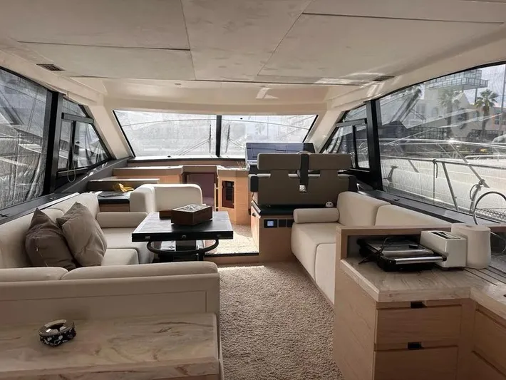 Rialtin Yacht Photos Pics Luxurious interior of 2022 Beneteau Monte Carlo 52 yacht with modern furnishings and panoramic windows.