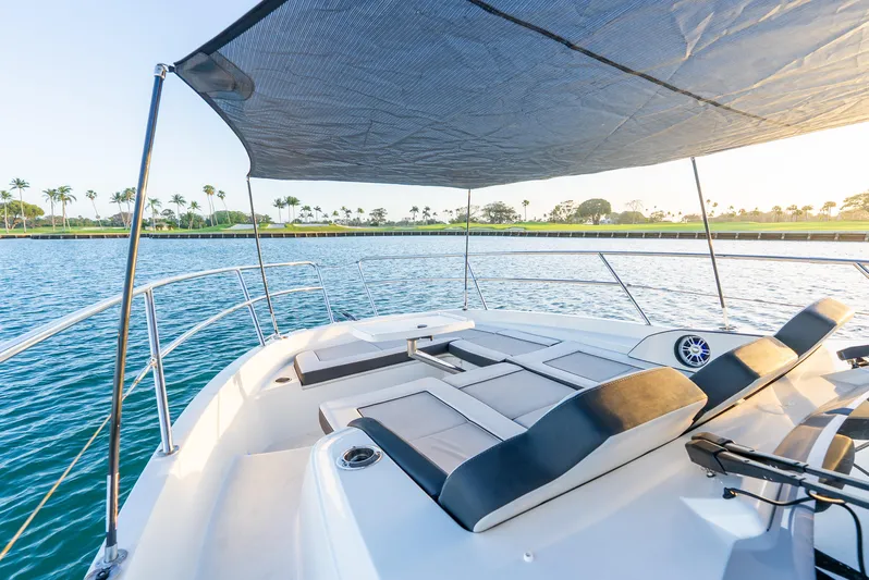  Yacht Photos Pics Jeanneau Leader 12.5 WA 2022 boat with sunshade on tranquil water.