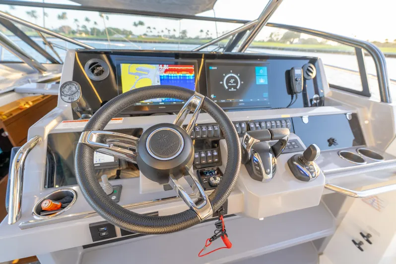  Yacht Photos Pics Cockpit of 2022 Jeanneau Leader 12.5 WA with modern navigation controls and steering wheel.