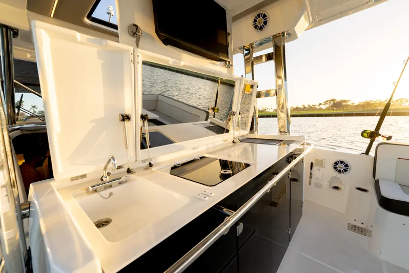  Yacht Photos Pics 2022 Jeanneau Leader 12.5 WA boat interior with sleek kitchen and water view.