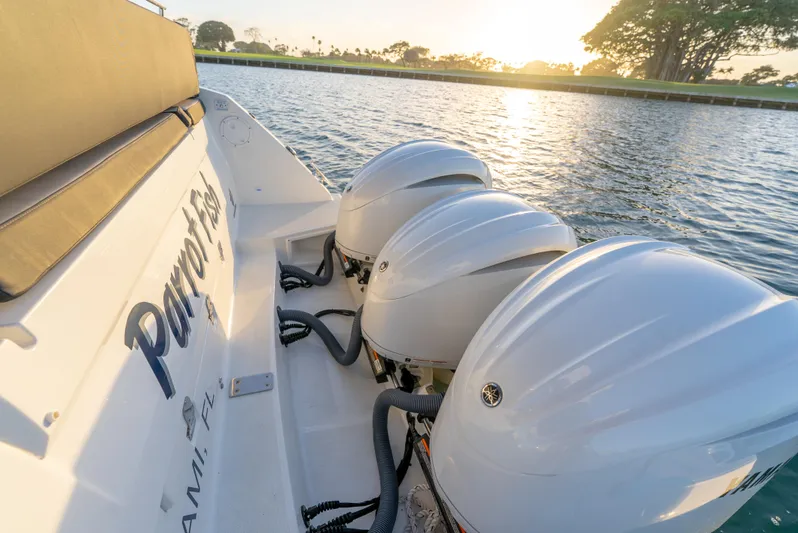  Yacht Photos Pics 2022 Jeanneau Leader 12.5 WA boat with triple outboard engines at sunset on the water.