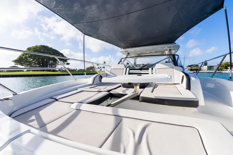  Yacht Photos Pics 2022 Jeanneau Leader 12.5 WA boat with sunshade, spacious deck, and scenic water view.