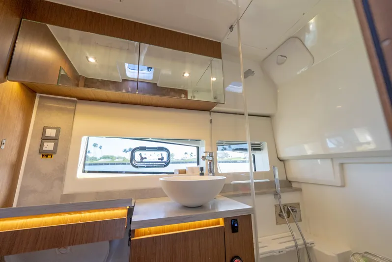  Yacht Photos Pics Luxurious bathroom interior of 2022 Jeanneau Leader 12.5 WA yacht with modern fixtures.