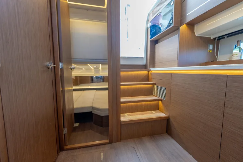  Yacht Photos Pics Interior of 2022 Jeanneau Leader 12.5 WA yacht, featuring wooden stairs and modern design.