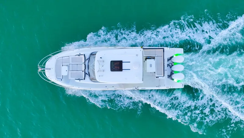 Yacht Photos Pics Top view of 2022 Jeanneau Leader 12.5 WA cruising on turquoise water.