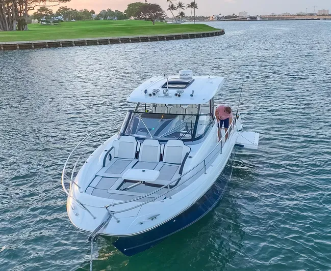  Yacht Photos Pics 2022 Jeanneau Leader 12.5 WA boat on water, scenic background with trees and sunset.