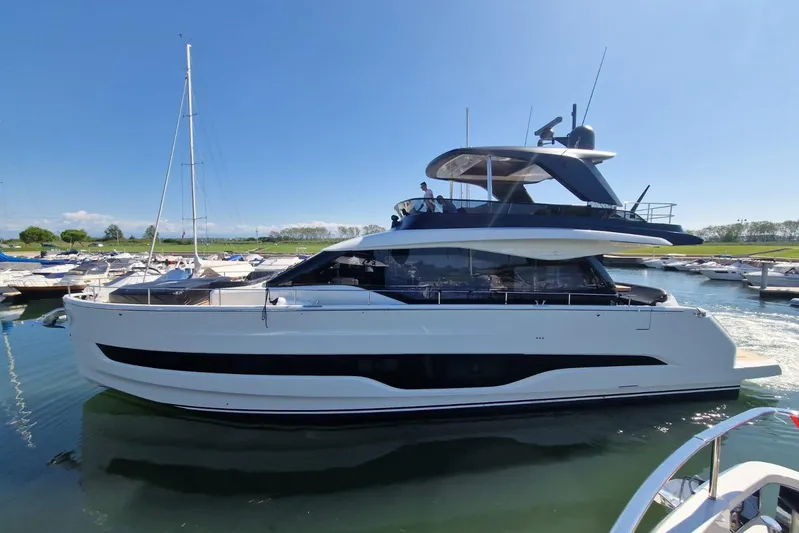  Yacht Photos Pics 2025 Cranchi Sessantadue 62 yacht docked in a marina under clear blue skies.