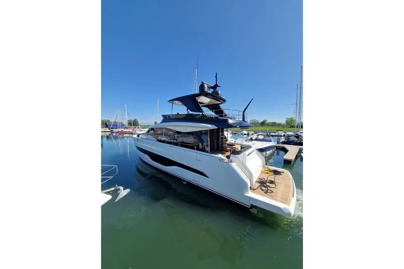  Yacht Photos Pics 2025 Cranchi Sessantadue 62 yacht docked in a marina under clear blue skies.