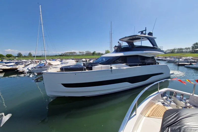  Yacht Photos Pics 2025 Cranchi Sessantadue 62 yacht docked in a sunny marina.