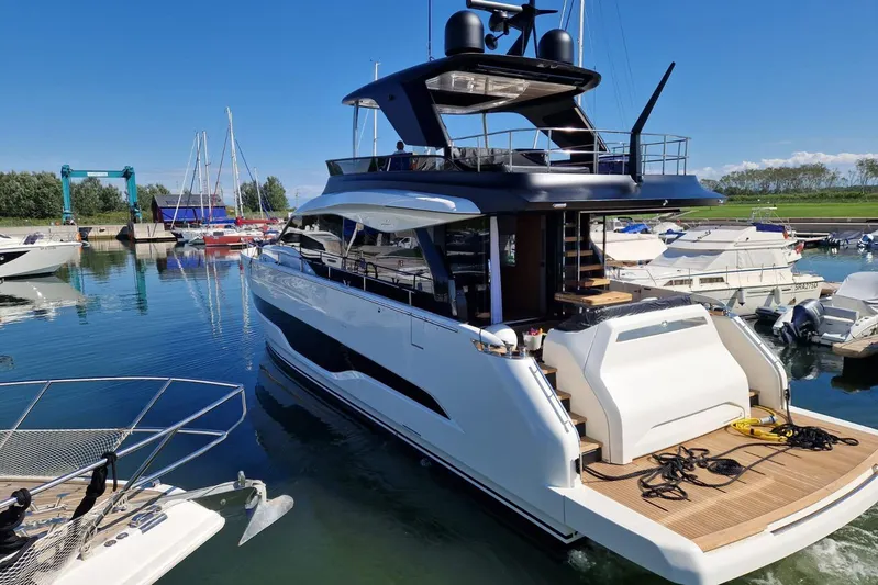  Yacht Photos Pics 2025 Cranchi Sessantadue 62 yacht docked in a marina under clear blue skies.