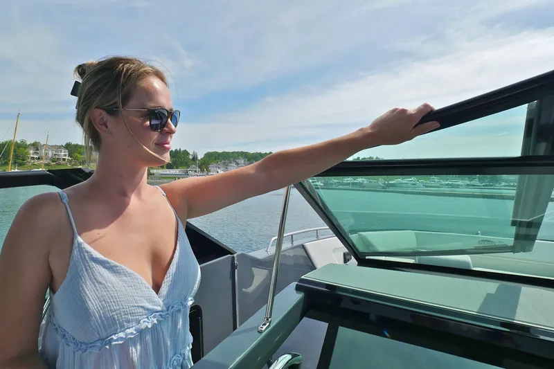  Yacht Photos Pics Woman enjoying a sunny day on a 2026 Cruisers Yachts 34 GLS I/O boat.
