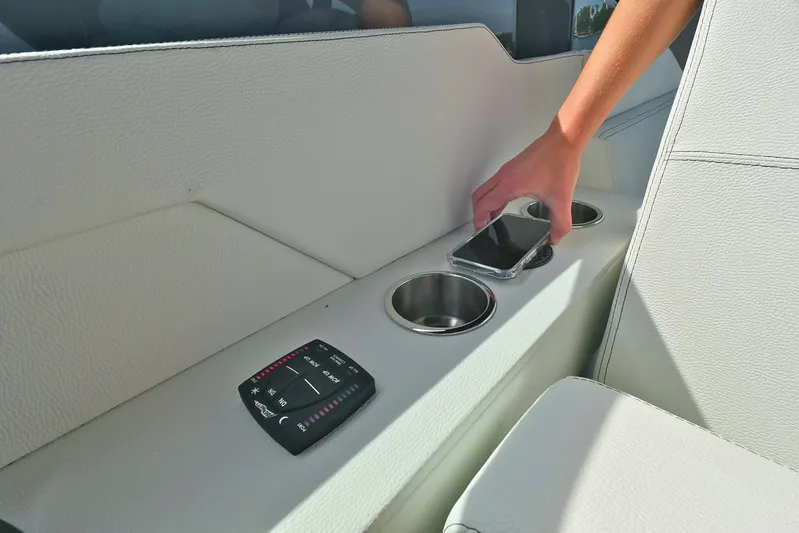  Yacht Photos Pics Hand placing phone in cup holder on 2026 Cruisers Yachts 34 GLS I/O.