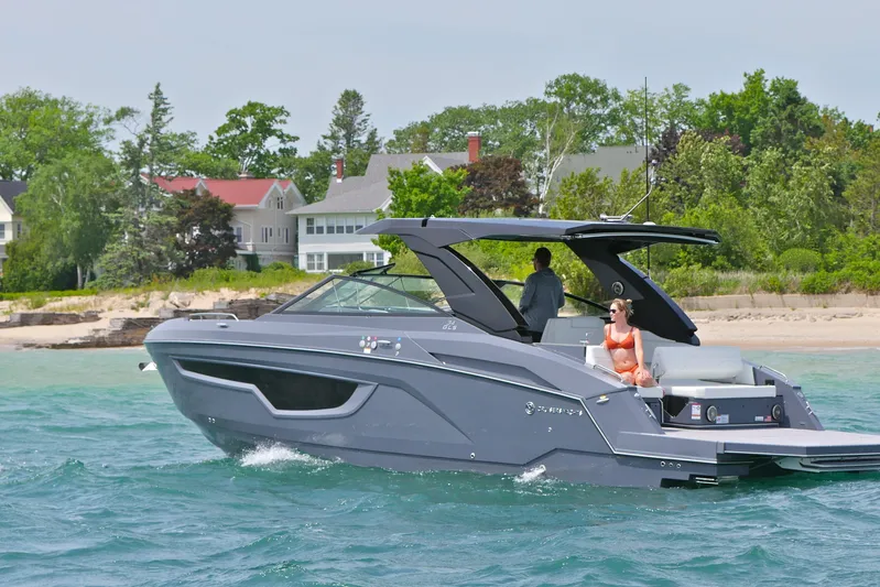  Yacht Photos Pics 2026 Cruisers Yachts 34 GLS I/O on water near shoreline, featuring sleek design and luxury amenities.