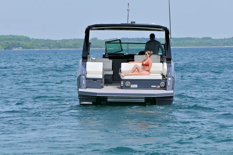  Yacht Photos Pics 2026 Cruisers Yachts 34 GLS I/O on open water, featuring passengers relaxing onboard.