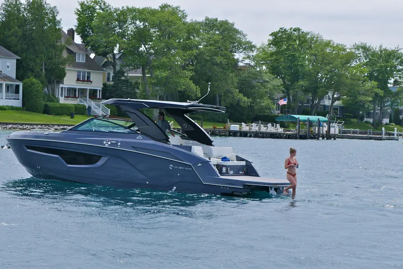  Yacht Photos Pics 2026 Cruisers Yachts 34 GLS I/O on water, with person enjoying the lake.