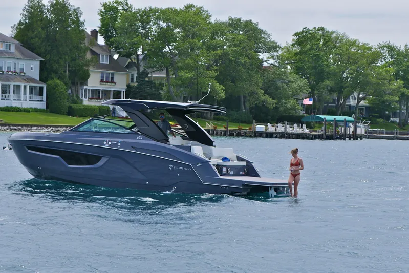  Yacht Photos Pics 2026 Cruisers Yachts 34 GLS I/O on water near shoreline homes.