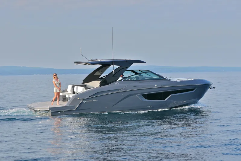  Yacht Photos Pics 2026 Cruisers Yachts 34 GLS I/O on calm water, featuring sleek design and modern amenities.