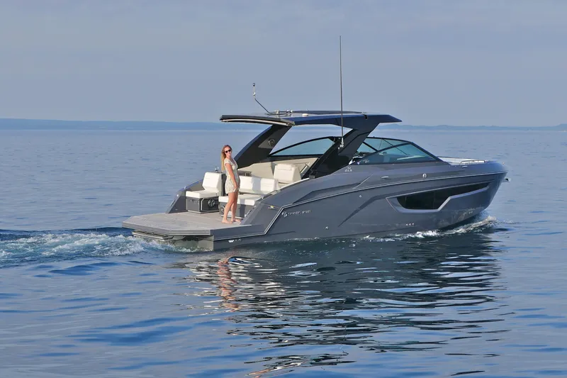  Yacht Photos Pics 2026 Cruisers Yachts 34 GLS I/O on calm water, featuring sleek design and luxury amenities.