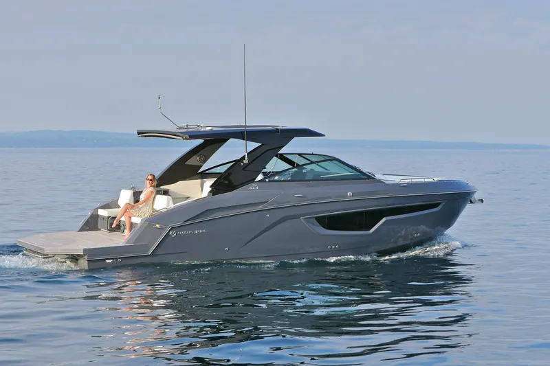  Yacht Photos Pics 2026 Cruisers Yachts 34 GLS I/O on calm water, featuring sleek design and luxury seating.