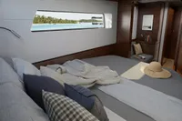 Luxurious Nautitech 44 Open 2025 cabin with ocean view, cozy bedding, and elegant decor.