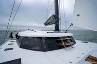 2025 Nautitech 44 Open catamaran sailing on open sea under cloudy skies.