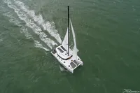 Aerial view of 2025 Nautitech 44 Open catamaran sailing on open water.