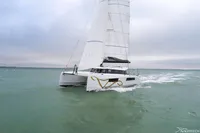 2026 Nautitech 44 Open catamaran sailing on open water under cloudy skies.