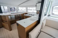 Modern interior of 2026 Nautitech 44 Open catamaran, featuring sleek kitchen and seating area.