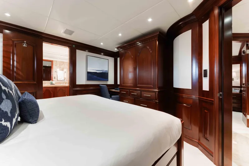Summerdance Yacht Photos Pics Luxurious 2004 Trinity Yachts motor yacht bedroom with elegant wood paneling and modern decor.