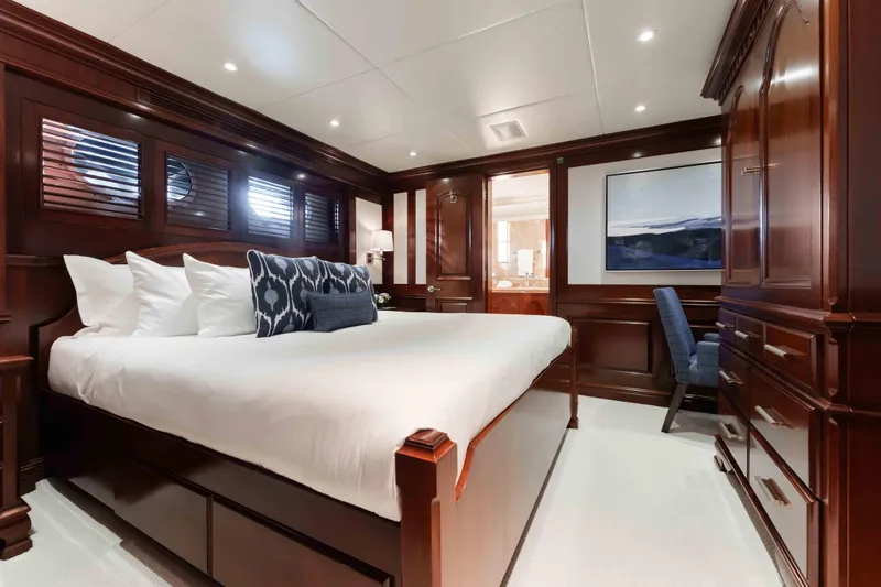 Summerdance Yacht Photos Pics Luxurious bedroom interior on 2004 Trinity Yachts motor yacht with elegant wood paneling.