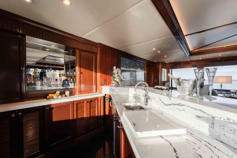 Summerdance Yacht Photos Pics Luxurious interior of 2004 Trinity Yachts motor yacht with elegant bar and marble countertops.