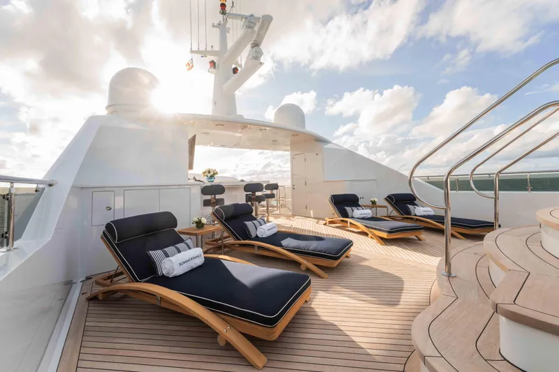 Summerdance Yacht Photos Pics Luxurious deck of 2004 Trinity Yachts motor yacht with sun loungers and ocean view.