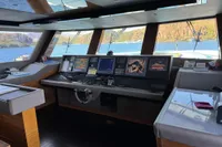 Bilgin Custom 150 yacht cockpit, 2014 model, with navigation screens and scenic ocean view.