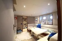 Luxurious yacht interior with white seating, table, and porthole windows, Bilgin Custom 150, 2014.
