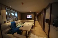 Luxurious interior of 2014 Bilgin Custom 150 yacht with cozy seating and TV.