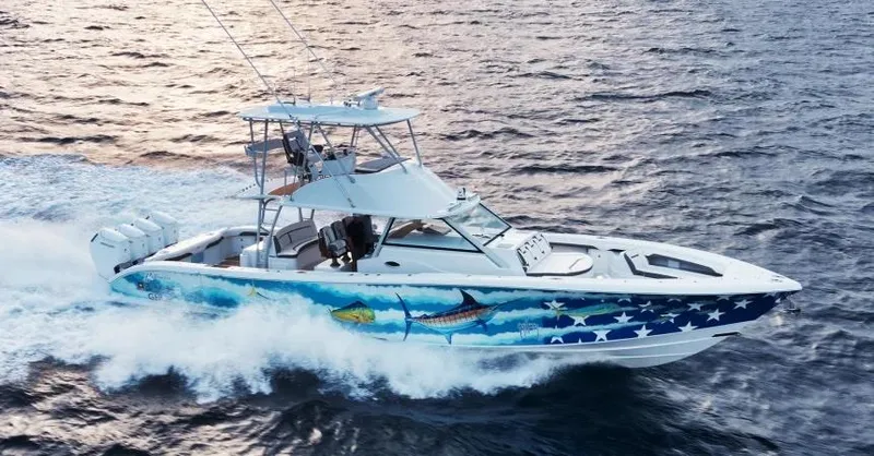  Yacht Photos Pics 2022 Yellowfin 54 Offshore boat cruising on ocean with vibrant marine artwork.