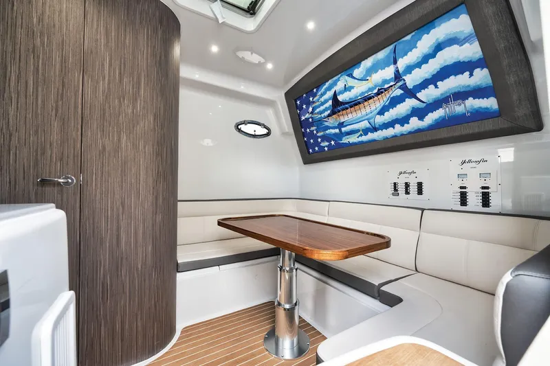  Yacht Photos Pics Interior of 2022 Yellowfin 54 Offshore boat with seating, table, and marlin artwork.