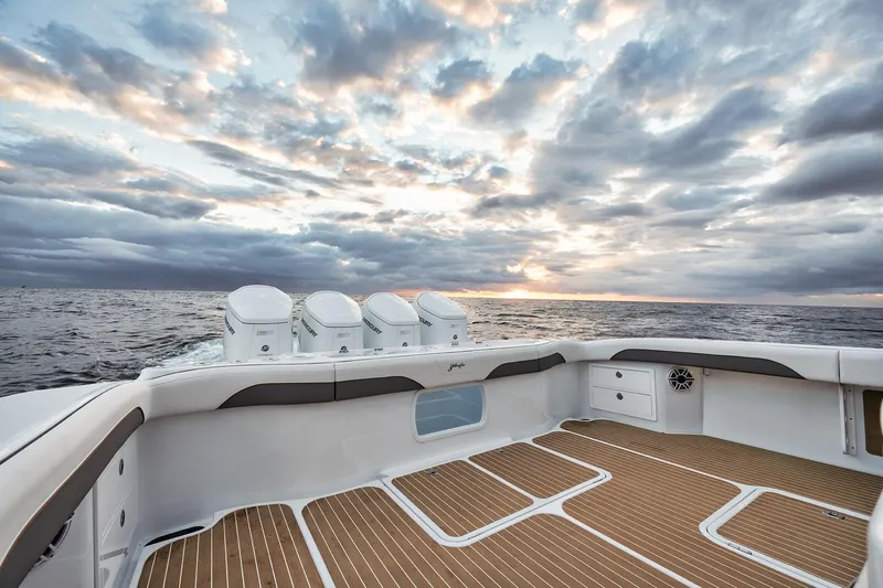  Yacht Photos Pics 2022 Yellowfin 54 Offshore boat deck with ocean view at sunset.