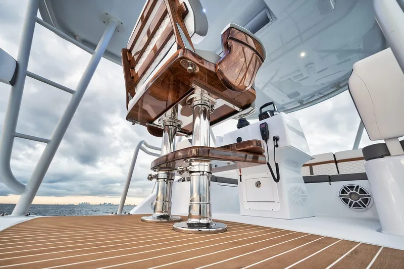 Yacht Photos Pics 2022 Yellowfin 54 Offshore boat interior with polished wood seating and sleek design.