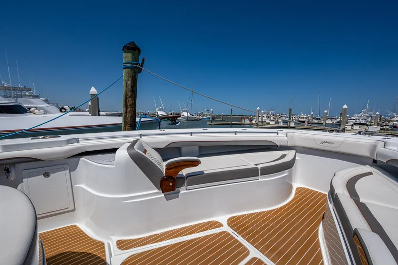  Yacht Photos Pics 2022 Yellowfin 54 Offshore boat with spacious seating at a marina.