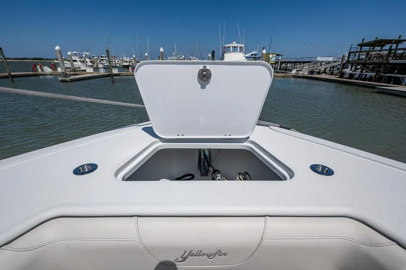  Yacht Photos Pics 2022 Yellowfin 54 Offshore boat with open storage compartment at marina.