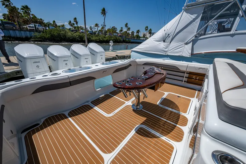  Yacht Photos Pics 2022 Yellowfin 54 Offshore boat deck with seating and fishing rod holders.