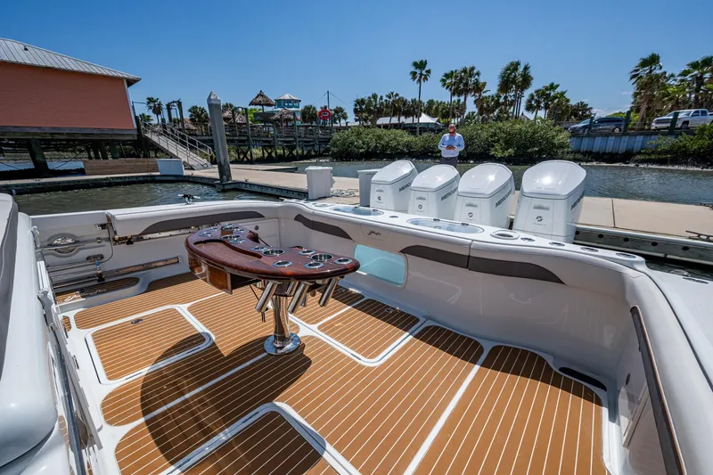  Yacht Photos Pics 2022 Yellowfin 54 Offshore boat with spacious deck and multiple engines docked at marina.