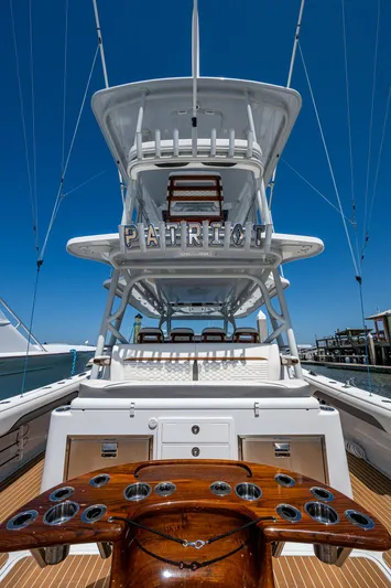  Yacht Photos Pics 2022 Yellowfin 54 Offshore yacht with tower and fishing rod holders, docked under clear blue sky.