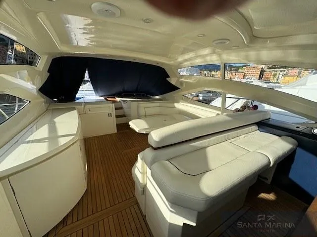  Yacht Photos Pics Luxurious interior of 2006 Cantieri di Sarnico 60 yacht with elegant seating and wood flooring.
