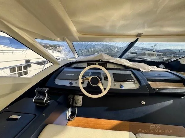  Yacht Photos Pics Interior view of 2006 Cantieri di Sarnico 60 yacht cockpit with steering wheel and controls.
