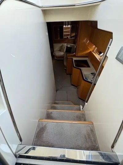  Yacht Photos Pics Interior view of 2006 Cantieri di Sarnico 60 yacht, featuring stairs and wooden cabinetry.