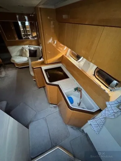  Yacht Photos Pics Interior of 2006 Cantieri di Sarnico 60 yacht with modern kitchen and seating area.